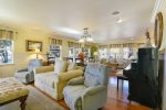 The living room is comfortably furnished with easy access to deck